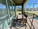 Covered patio with table and chairs overlooking pool area at 8900 Takeaway Way, Davenport, FL 33896