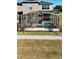 Screened-in pool and spa with a gray stone wall at 8900 Takeaway Way, Davenport, FL 33896