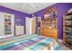 Purple bedroom with a bed, dresser, and a tv at 1021 Siena Park E Blvd # 103, Kissimmee, FL 34747