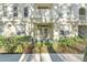 Building exterior, unit 1021, with double doors and landscaping at 1021 Siena Park E Blvd # 103, Kissimmee, FL 34747