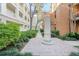 Landscaped courtyard with brick pathway and obelisk at 1021 Siena Park E Blvd # 103, Kissimmee, FL 34747