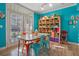 Small dining area with teal walls, metal chairs, and a small table at 1021 Siena Park E Blvd # 103, Kissimmee, FL 34747
