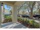 Covered front porch with view of tree-lined street at 1021 Siena Park E Blvd # 103, Kissimmee, FL 34747