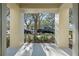 Covered front porch overlooking a tree-lined street at 1021 Siena Park E Blvd # 103, Kissimmee, FL 34747
