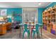 Home office features teal walls, a desk, and a large bookshelf at 1021 Siena Park E Blvd # 103, Kissimmee, FL 34747