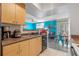 Modern kitchen features light wood cabinets and a view into the dining area at 1021 Siena Park E Blvd # 103, Kissimmee, FL 34747