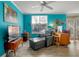 Living room with teal walls, gray chaise lounge, and TV at 1021 Siena Park E Blvd # 103, Kissimmee, FL 34747