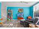 Living room with teal walls and wood-look floors at 1021 Siena Park E Blvd # 103, Kissimmee, FL 34747