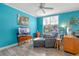 Living room with teal walls, gray chaise lounge, and TV at 1021 Siena Park E Blvd # 103, Kissimmee, FL 34747