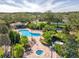 Community pool and spa with lush landscaping and lounge chairs at 11350 Cypress Trail Dr, Orlando, FL 32825