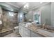 Spa-like bathroom with double vanity, granite countertop, and large shower at 1261 Radiant St, Reunion, FL 34747