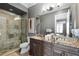 Modern bathroom with double vanity, granite countertop and a walk-in shower at 1261 Radiant St, Reunion, FL 34747