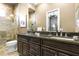 Elegant bathroom with double vanity, granite countertop and large shower at 1261 Radiant St, Reunion, FL 34747
