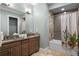 Modern bathroom with double vanity, granite countertop, and cactus shower curtain at 1261 Radiant St, Reunion, FL 34747