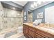 Elegant bathroom with double vanity, large shower, and granite countertop at 1261 Radiant St, Reunion, FL 34747