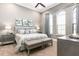 Serene bedroom with king-size bed, gray color scheme, and two ottomans at 1261 Radiant St, Reunion, FL 34747