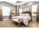 Sophisticated bedroom with king-size bed, neutral tones, and large windows at 1261 Radiant St, Reunion, FL 34747