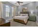 Bright bedroom featuring a king-size bed and large windows at 1261 Radiant St, Reunion, FL 34747