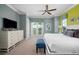 Spacious bedroom with king bed, dresser, and access to balcony at 1261 Radiant St, Reunion, FL 34747
