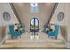 Grand entryway with double staircase and seating area at 1261 Radiant St, Reunion, FL 34747