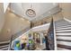 Elegant entryway with sweeping staircase and chandelier at 1261 Radiant St, Reunion, FL 34747