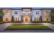 Elegant two-story home with a grand entrance and manicured lawn at 1261 Radiant St, Reunion, FL 34747