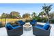 Relaxing fire pit area with wicker seating for four at 1261 Radiant St, Reunion, FL 34747