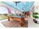 Pool table in a game room with a painted ceiling and balcony access at 1261 Radiant St, Reunion, FL 34747