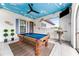 Game room features a pool table, a painted ceiling, and a large TV at 1261 Radiant St, Reunion, FL 34747
