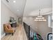 Elegant upper hallway with light wood floors and a large chandelier at 1261 Radiant St, Reunion, FL 34747