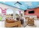 Relaxing lounge area with wicker furniture and a painted ceiling at 1261 Radiant St, Reunion, FL 34747