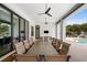 Covered outdoor dining area with large table and seating for ten at 1261 Radiant St, Reunion, FL 34747