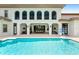 Resort-style pool with outdoor kitchen and lounge area at 1261 Radiant St, Reunion, FL 34747