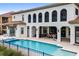 Luxury pool and spa with outdoor kitchen and seating at 1261 Radiant St, Reunion, FL 34747