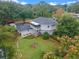 Aerial view of a two-story house with a screened porch and garden at 1399 Old Mount Dora Rd, Eustis, FL 32726