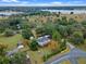 Aerial view of a house near a lake, showcasing a large property and surrounding landscape at 1399 Old Mount Dora Rd, Eustis, FL 32726