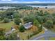 Aerial view of a house near a lake, showcasing a large property and surrounding landscape at 1399 Old Mount Dora Rd, Eustis, FL 32726
