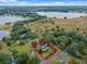 Aerial view of a house near a lake, showcasing a large property and surrounding landscape at 1399 Old Mount Dora Rd, Eustis, FL 32726