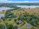 Aerial view of a house near a lake, showcasing a large property and surrounding landscape at 1399 Old Mount Dora Rd, Eustis, FL 32726