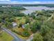 Aerial view of a house near a lake, showcasing a large property and surrounding landscape at 1399 Old Mount Dora Rd, Eustis, FL 32726