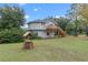 Large backyard with circular home, wooden deck and well at 1399 Old Mount Dora Rd, Eustis, FL 32726