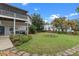 Large backyard with a grassy area and brick pathway at 1399 Old Mount Dora Rd, Eustis, FL 32726