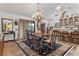 Elegant dining room with chandelier and wood table, showcasing a view to the kitchen at 1399 Old Mount Dora Rd, Eustis, FL 32726