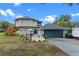 Home with circular design, detached garage, and landscaped patio area at 1399 Old Mount Dora Rd, Eustis, FL 32726