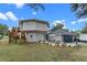 Circular home with deck, detached garage, and landscaped patio area at 1399 Old Mount Dora Rd, Eustis, FL 32726