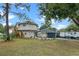 Circular home with elevated deck, detached garage, and RV parking at 1399 Old Mount Dora Rd, Eustis, FL 32726