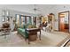 Cozy living room with green sofa and large windows, offering natural light at 1399 Old Mount Dora Rd, Eustis, FL 32726