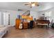 Living room with hardwood floors, piano, and home office at 1399 Old Mount Dora Rd, Eustis, FL 32726