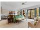 Bright living room with green sofa and access to a balcony at 1399 Old Mount Dora Rd, Eustis, FL 32726
