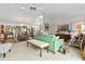 Open living room with green sofa and views to dining and kitchen areas at 1399 Old Mount Dora Rd, Eustis, FL 32726
